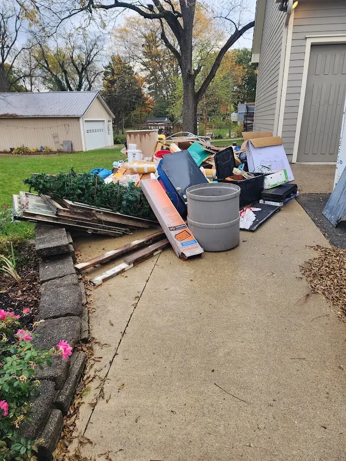 Dumpster being loaded with debris for 12 Yard Dumpster Rental in Wallburg